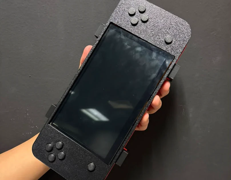 3D-printed handheld game console held in one hand